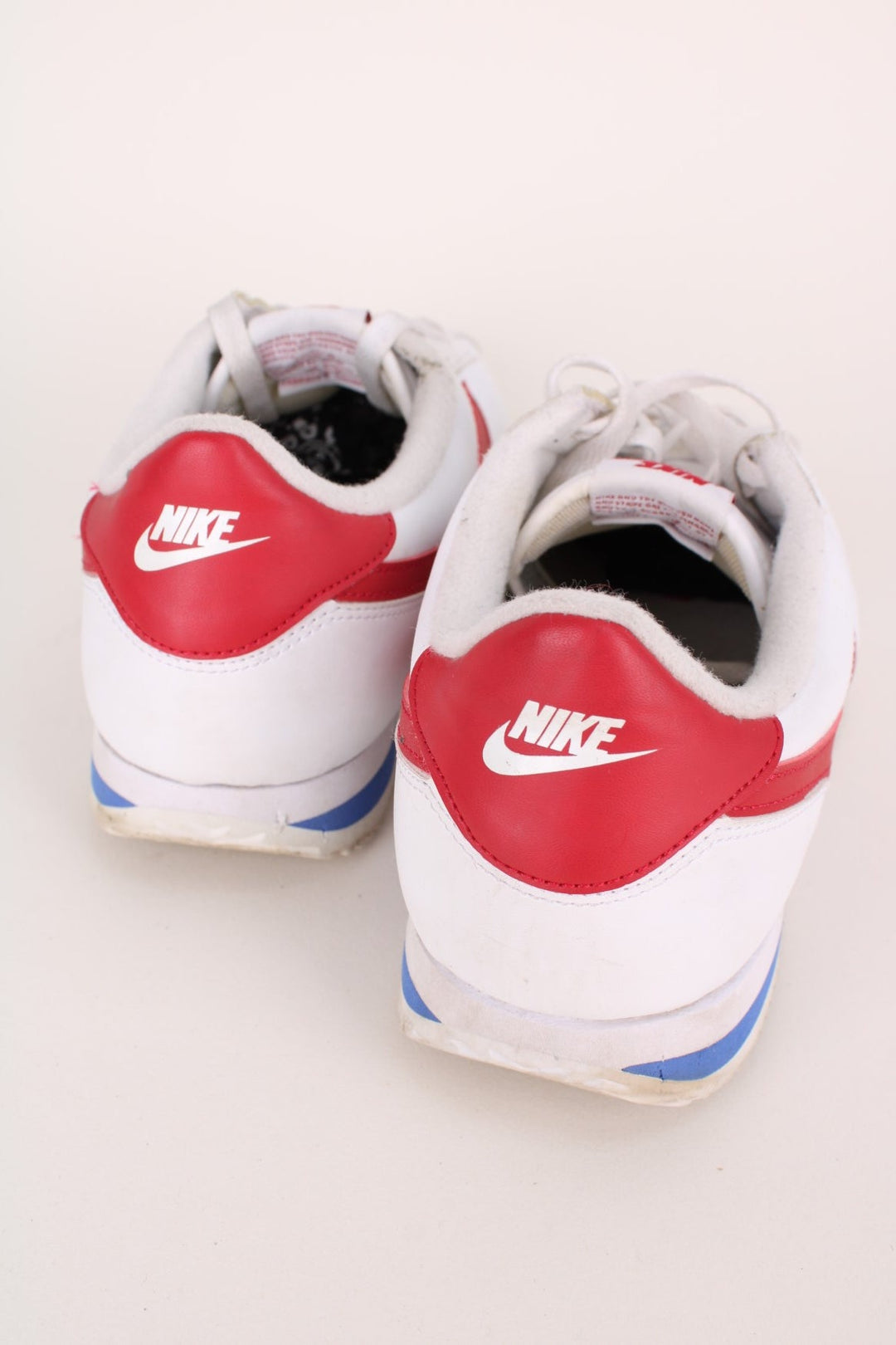 Vintage Nike Classic OG Cortez in a white, red and blue colourway with the swoosh logo embroidered on the sides, and has adjustable laces.