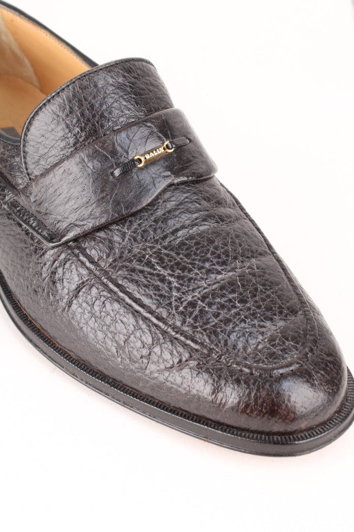 Vintage Bally Loafers in a black colourway with the gold logo badge on the front.