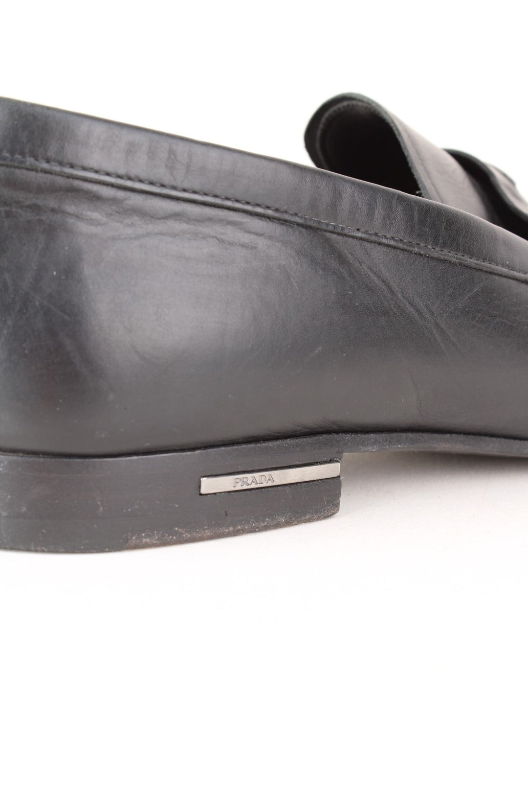 Vintage Prada Loafers in a black colourway with the badge logo embroidered on the front and side heels.