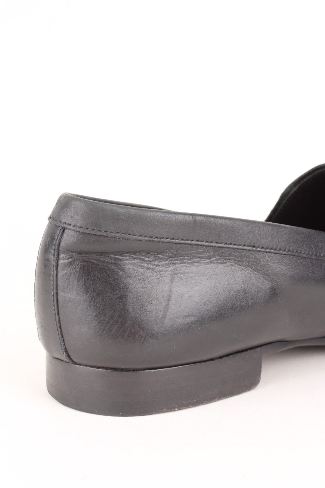 Vintage Prada Loafers in a black colourway with the badge logo embroidered on the front and side heels.