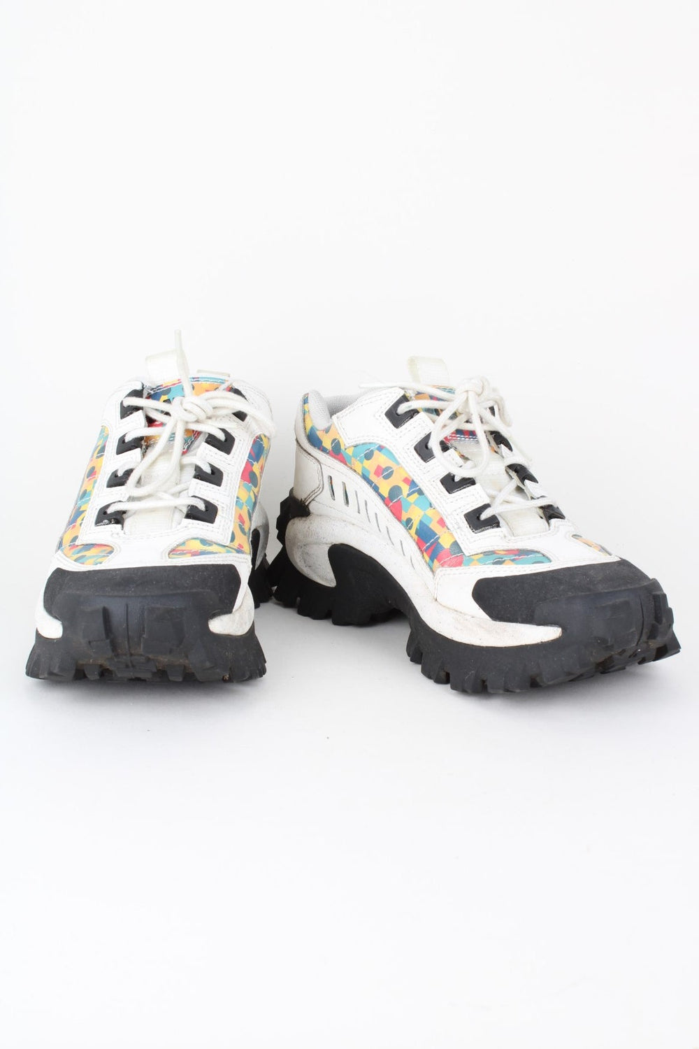 Vintage CAT Caterpillar Intruder Shoes in a white colourway with multicoloured patterned stripe going down the sides, and has laces.