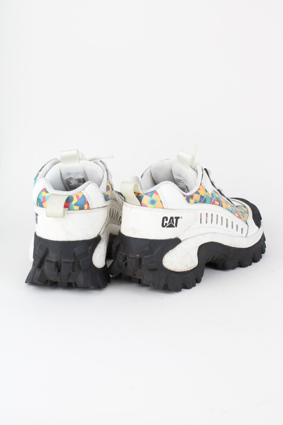 Vintage CAT Caterpillar Intruder Shoes in a white colourway with multicoloured patterned stripe going down the sides, and has laces.