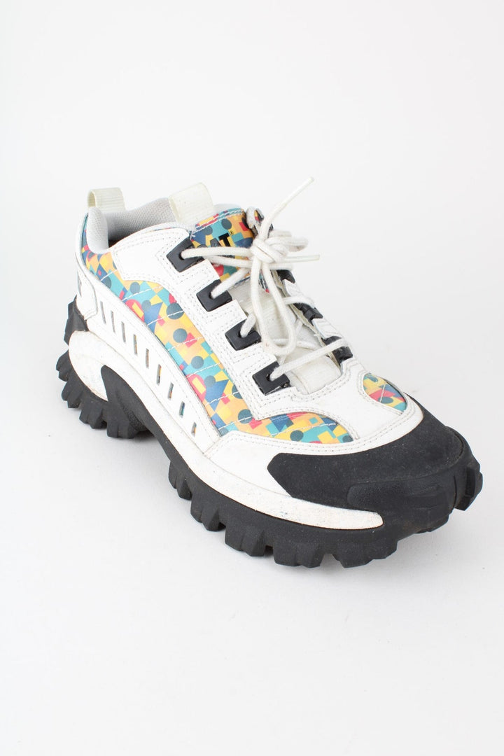 Vintage CAT Caterpillar Intruder Shoes in a white colourway with multicoloured patterned stripe going down the sides, and has laces.