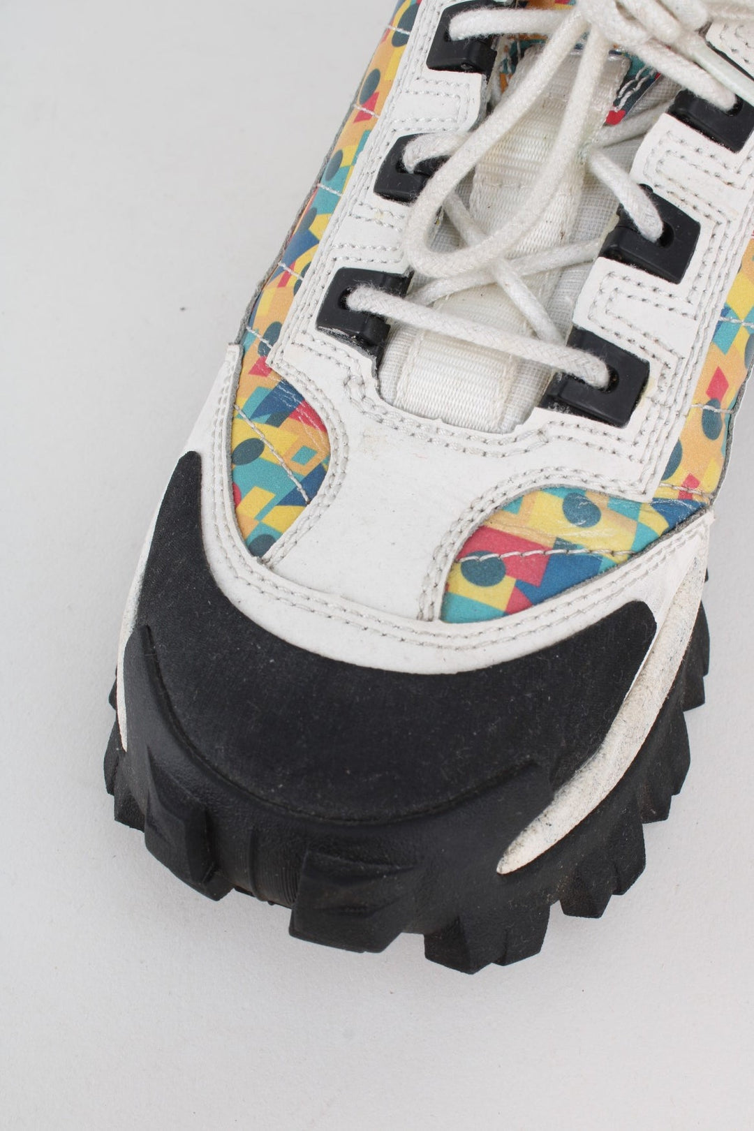 Vintage CAT Caterpillar Intruder Shoes in a white colourway with multicoloured patterned stripe going down the sides, and has laces.