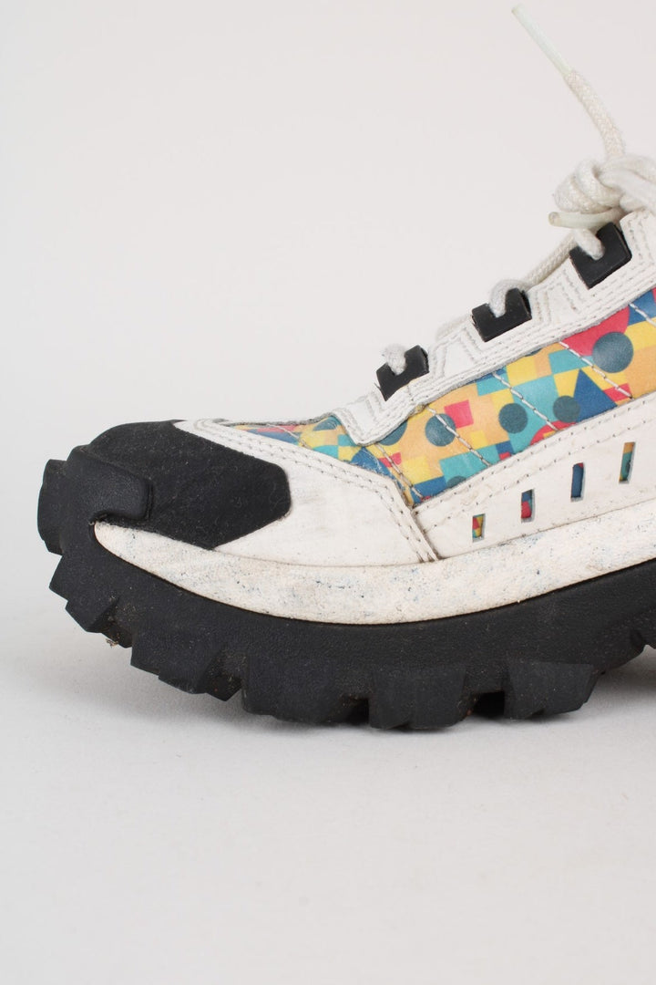 Vintage CAT Caterpillar Intruder Shoes in a white colourway with multicoloured patterned stripe going down the sides, and has laces.