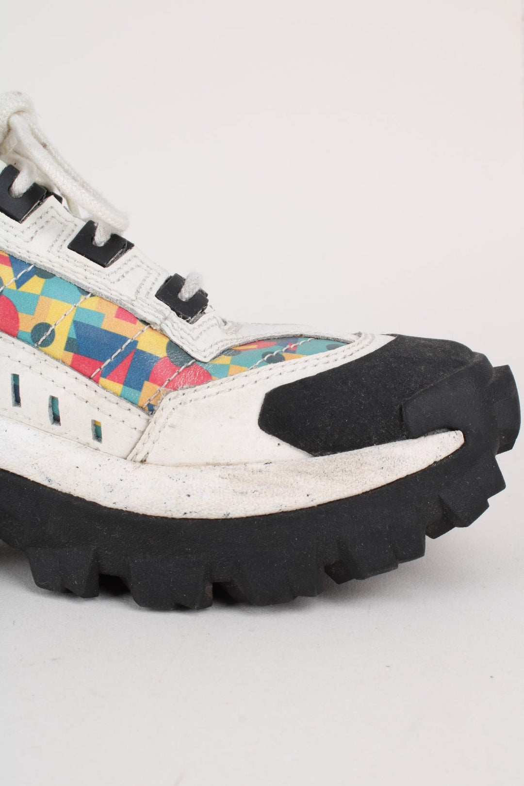 Vintage CAT Caterpillar Intruder Shoes in a white colourway with multicoloured patterned stripe going down the sides, and has laces.