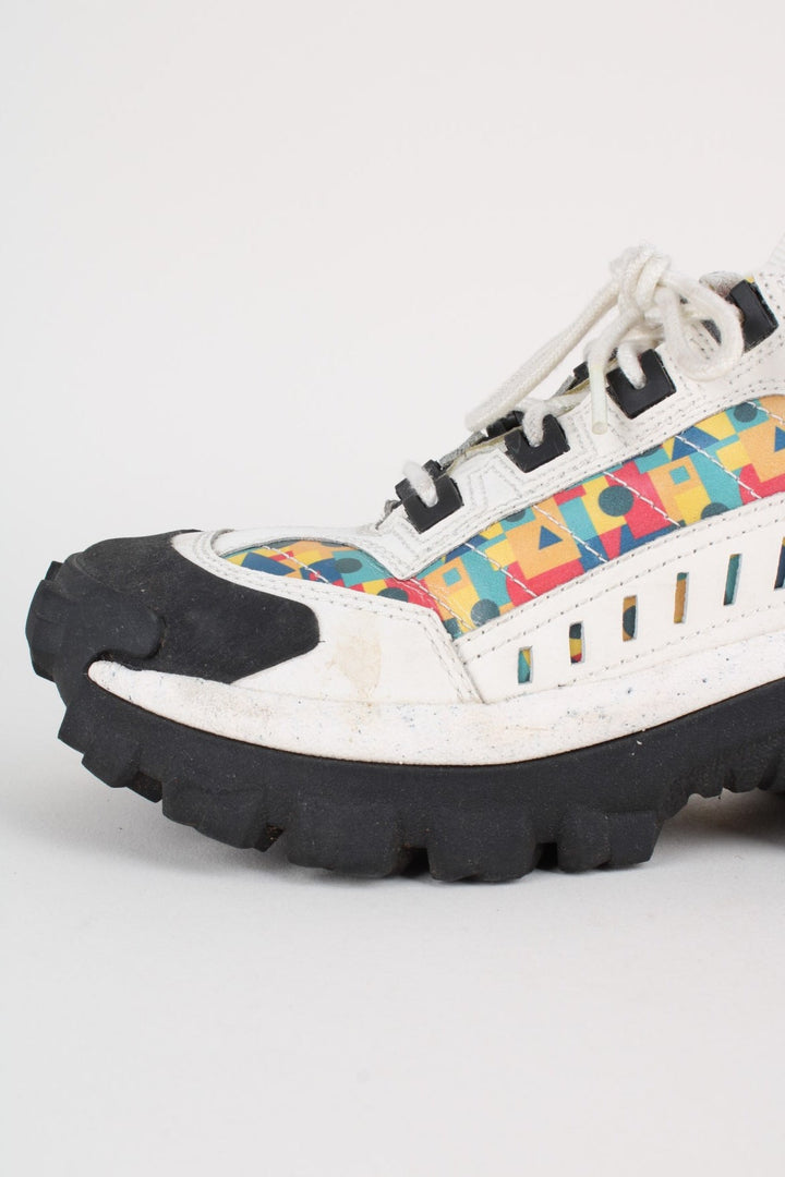 Vintage CAT Caterpillar Intruder Shoes in a white colourway with multicoloured patterned stripe going down the sides, and has laces.