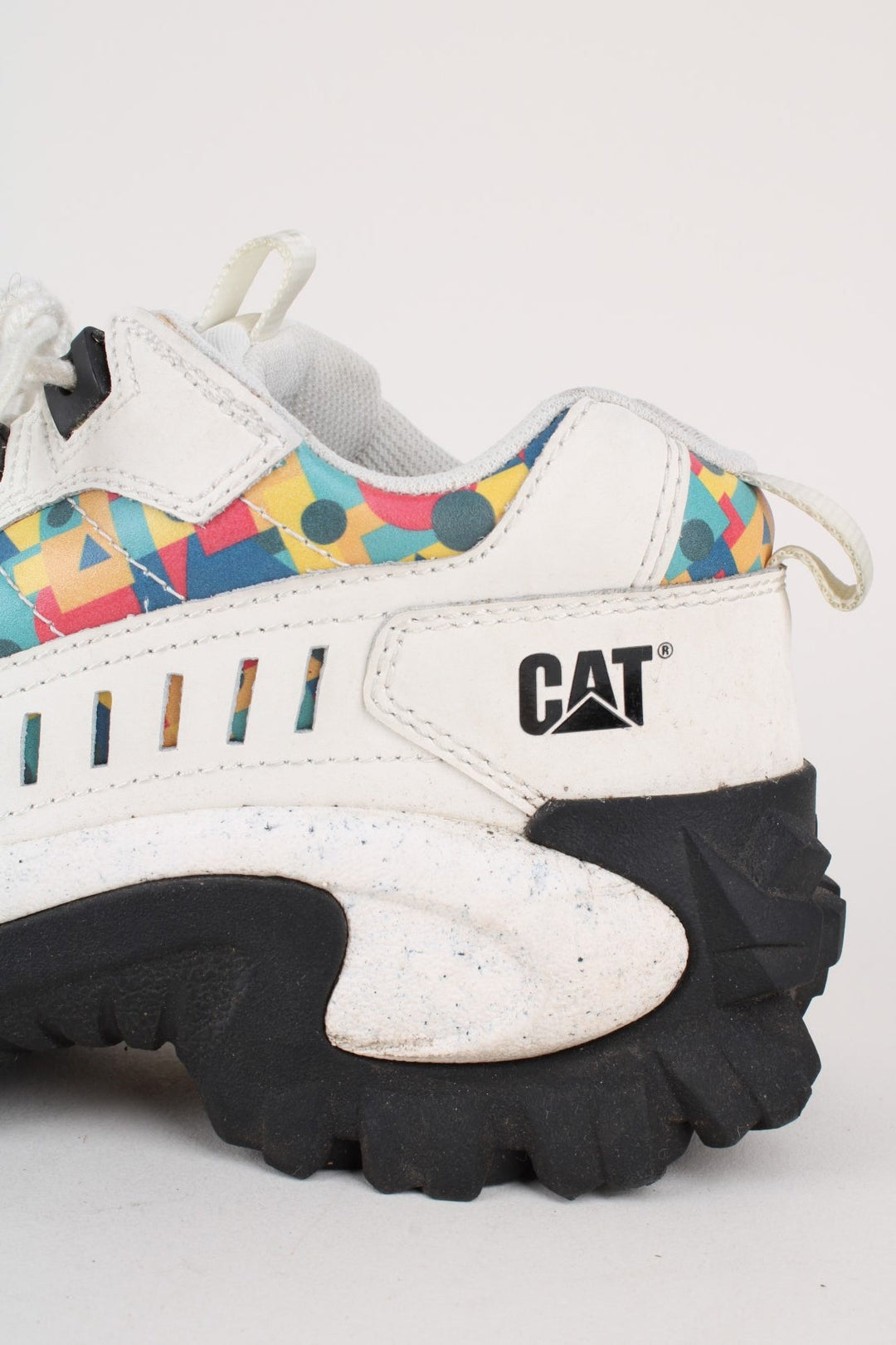 Vintage CAT Caterpillar Intruder Shoes in a white colourway with multicoloured patterned stripe going down the sides, and has laces.