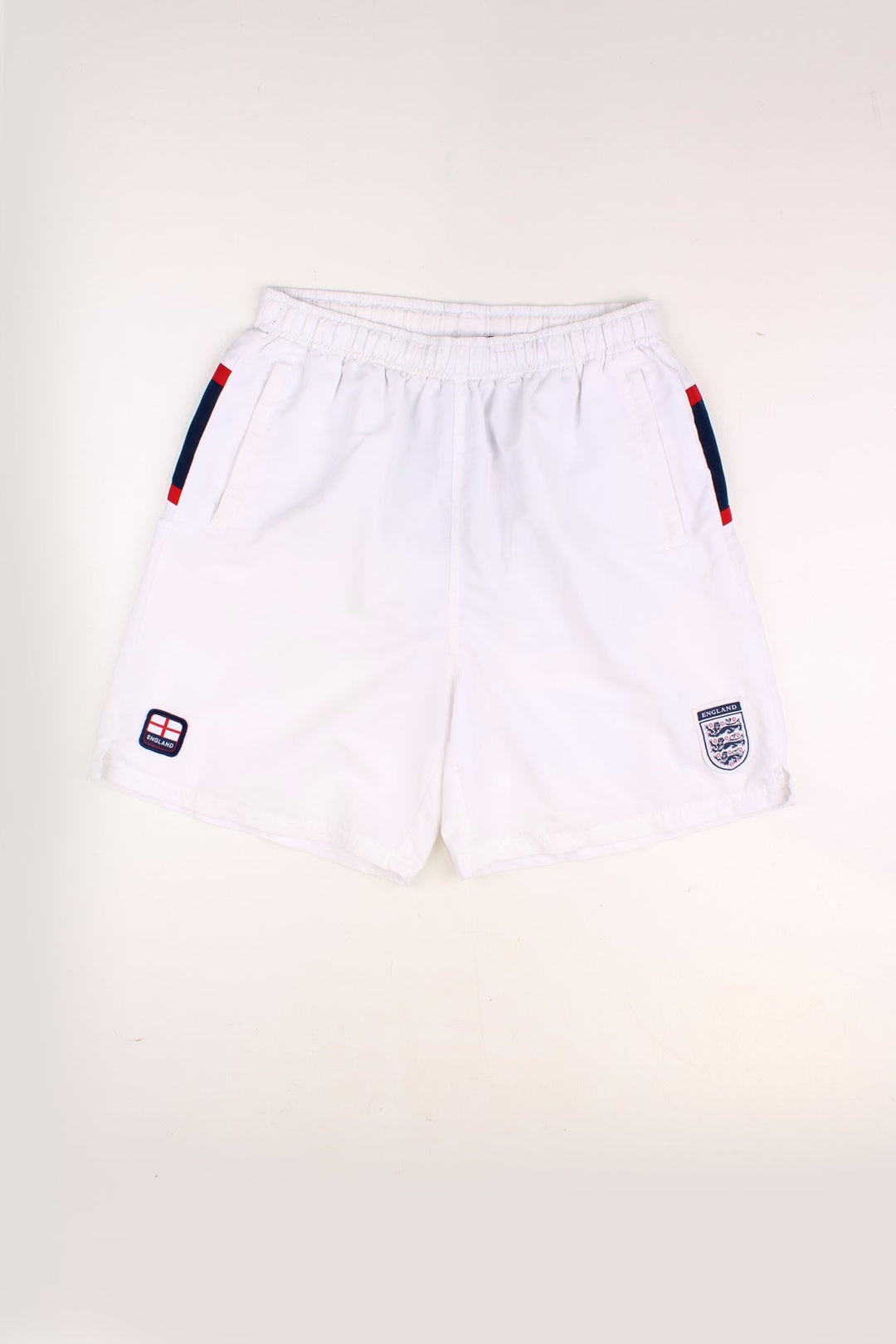 Vintage England Football Team Shorts in a white colourway, adjustable waist, netted lining, pockets and has the team logos embroidered on the front as well as 'England' spell out printed across the back. 