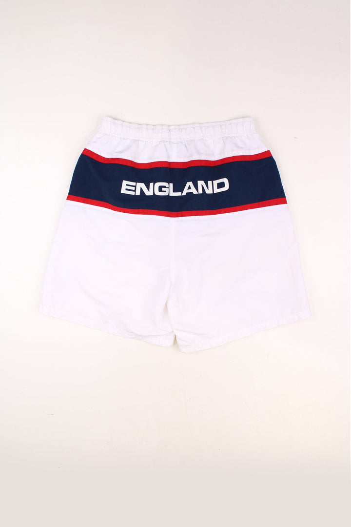 Vintage England Football Team Shorts in a white colourway, adjustable waist, netted lining, pockets and has the team logos embroidered on the front as well as 'England' spell out printed across the back. 