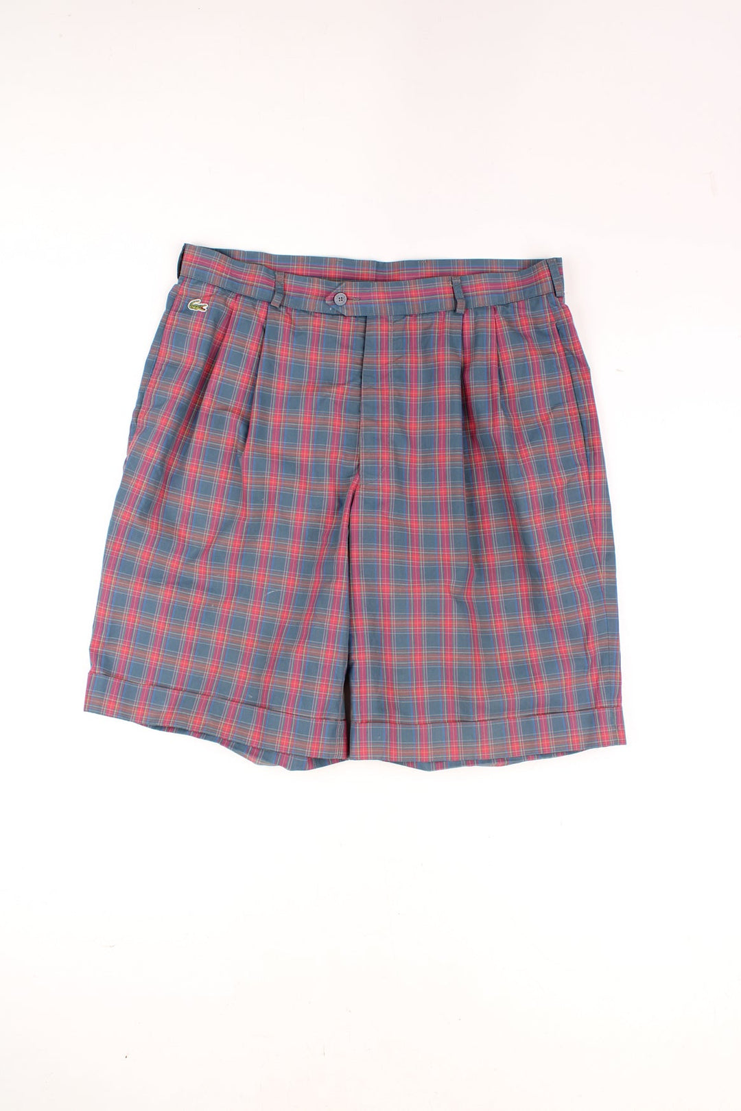 Vintage Lacoste Tartan Shorts in a red, blue and green colourway, and has the logo embroidered on the front. 