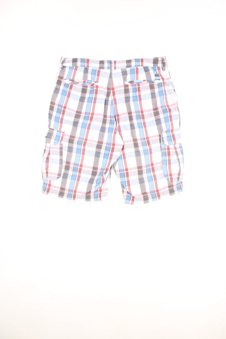 Quiksilver Shorts in a white, blue and red checkered colourway, has multiple pockets, and the logo embroidered on the front and back. 