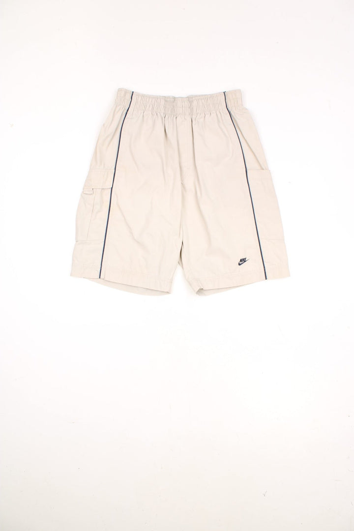 Nike Cargo Shorts in a tanned colourway with a blue stripe going down either side, multiple pockets, and has the logo embroidered on the front. 