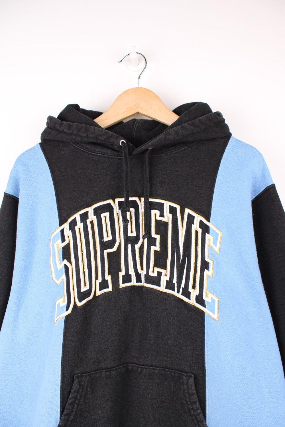 Supreme paneled Arc hoodie in a blue and black colourway with spell out logo across the chest. 