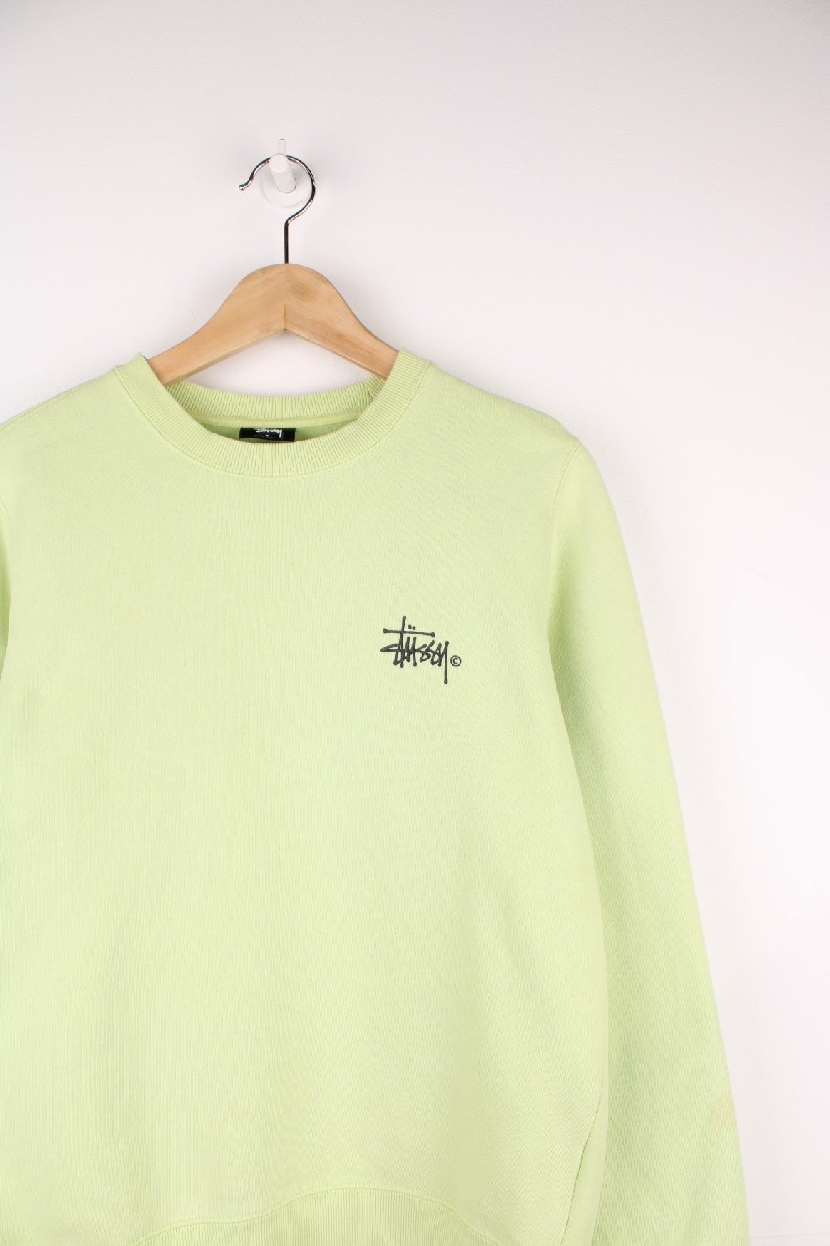 Lime green stussy crewneck sweatshirt with printed spell-out logo on the chest and back