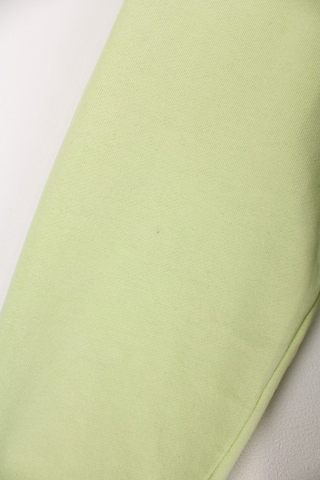 Lime green stussy crewneck sweatshirt with printed spell-out logo on the chest and back