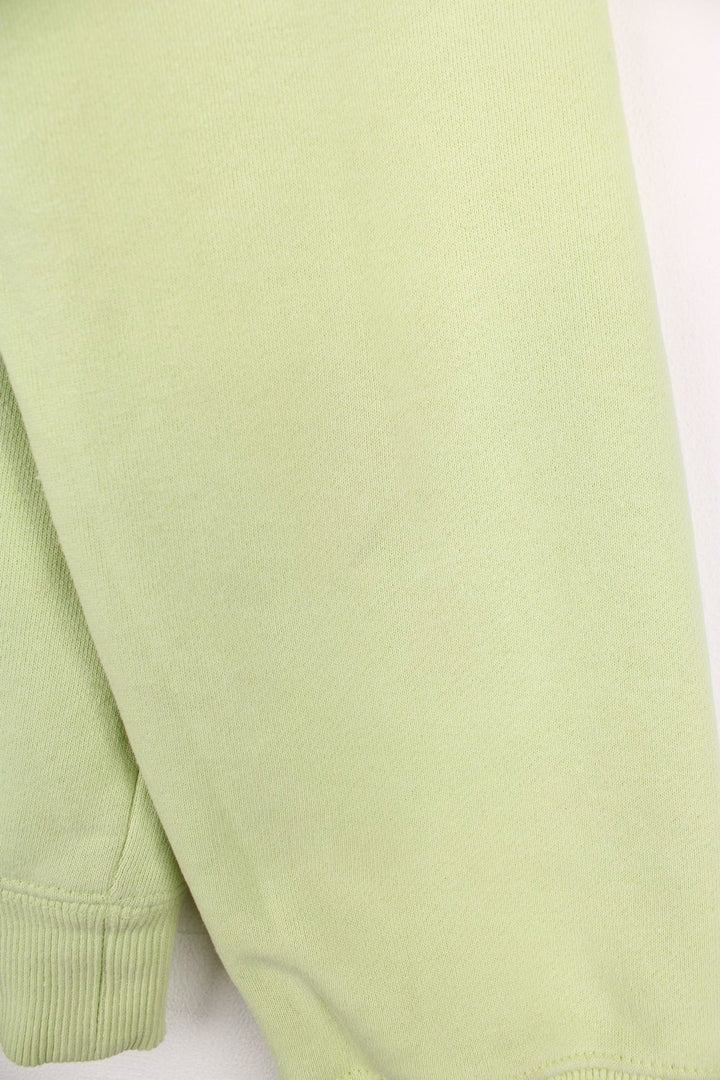 Lime green stussy crewneck sweatshirt with printed spell-out logo on the chest and back