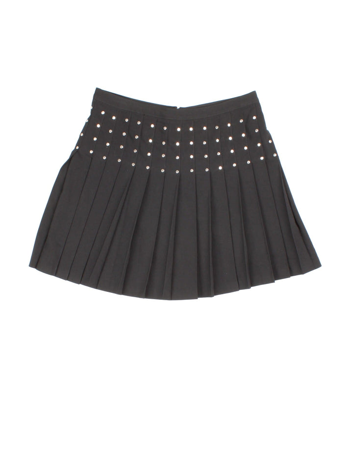 Y2K pleated mini skirt in black with silver stud detailing and zip closure.