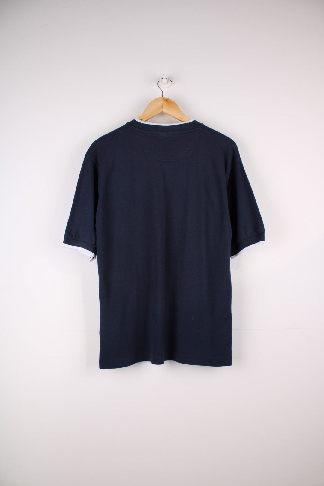 1990s Nike T-Shirt in a navy blue colourway. The T shirt has a V neck, cuffed sleeves and a small embroidered logo on the front.  