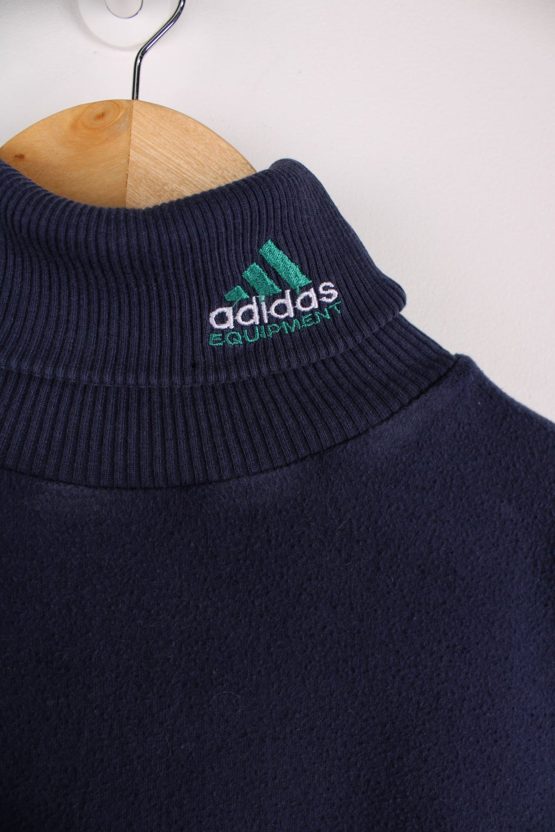 1990s Adidas Equipment longsleeve T-Shirt in a navy blue colourway with the logo embroidered on the collar and a patch sewn into the arm.