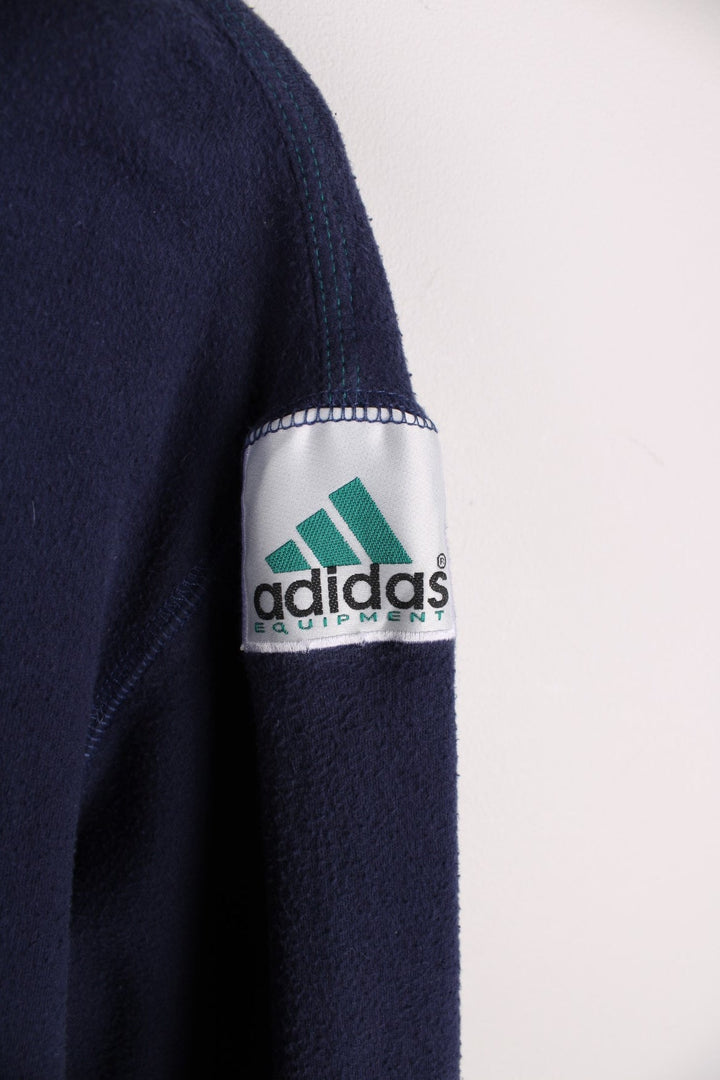 1990s Adidas Equipment longsleeve T-Shirt in a navy blue colourway with the logo embroidered on the collar and a patch sewn into the arm.