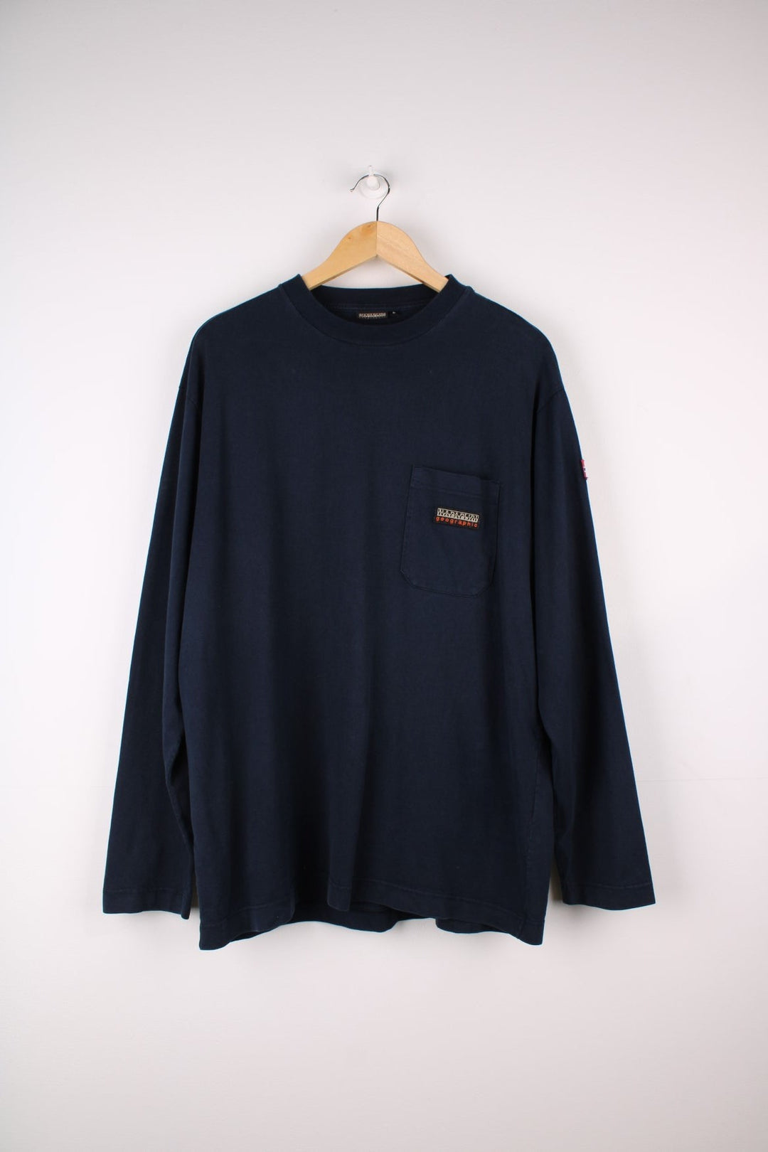 Napapijri long sleeve T-Shirt in a navyblue colourway with a front patch pocket, stiched logo and a Norwegian flag stitched on the arm.