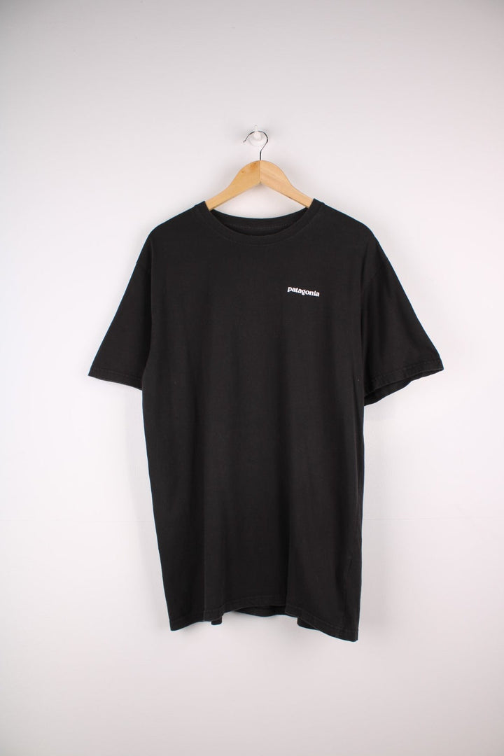 Patagonia T-Shirt in a black colourway with the Patagonia logo printed on the front, and a large print on the back.