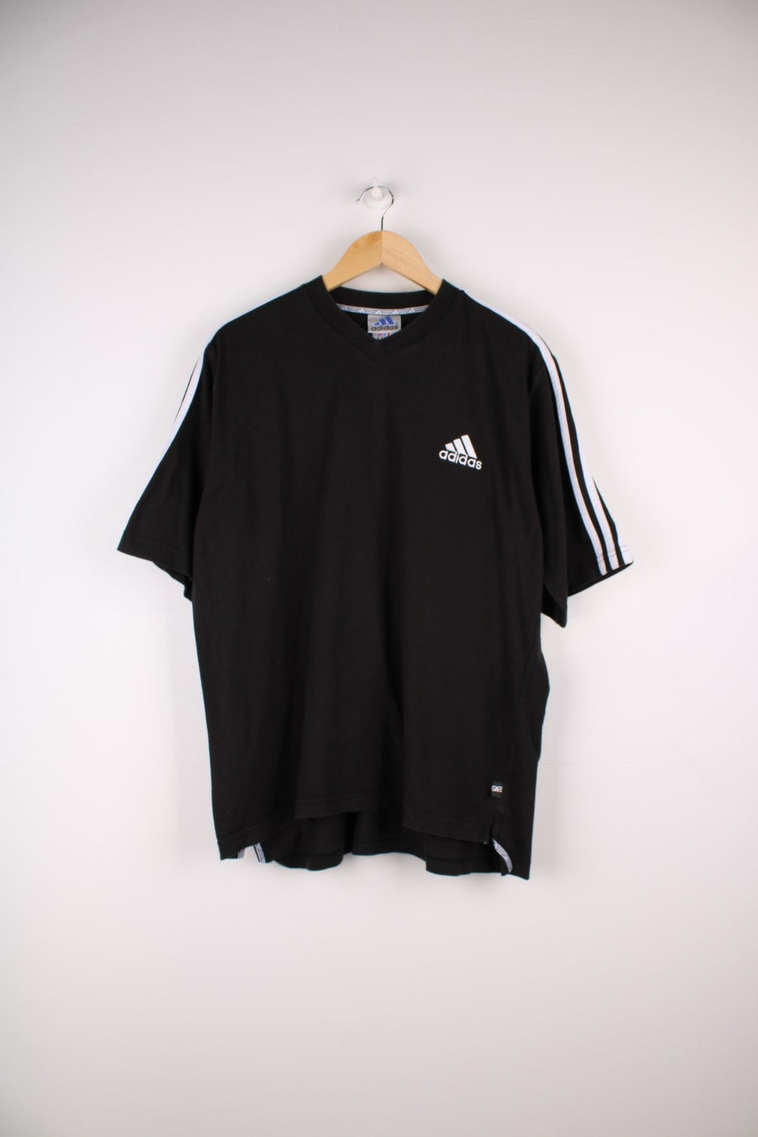 1990s Adidas T-Shirt in a black colourway with the logo embroidered on the front and three stripes stitched down the sleeves. 