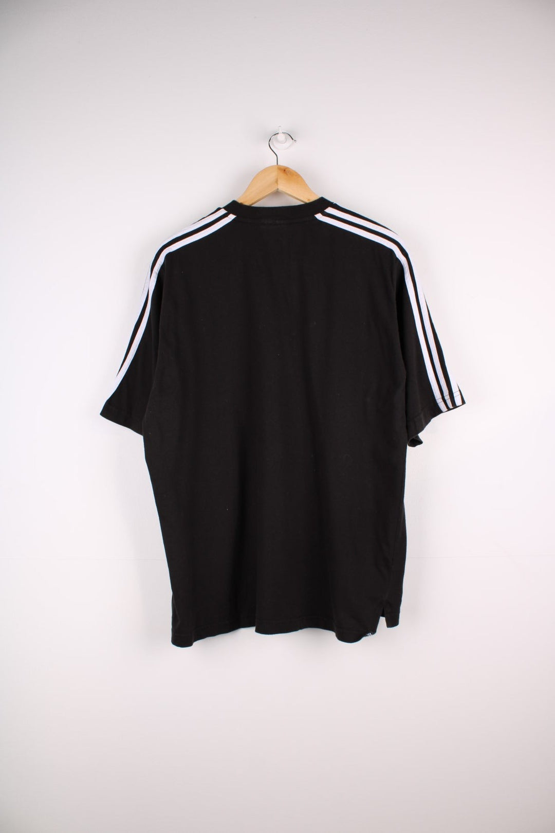 1990s Adidas T-Shirt in a black colourway with the logo embroidered on the front and three stripes stitched down the sleeves. 