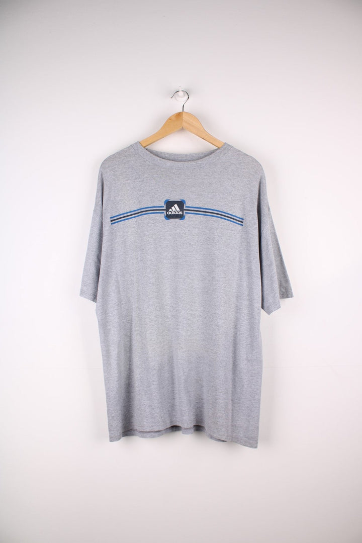 Vintage Early 2000s Adidas T-Shirt in a grey colourway a graphic printed on the front..