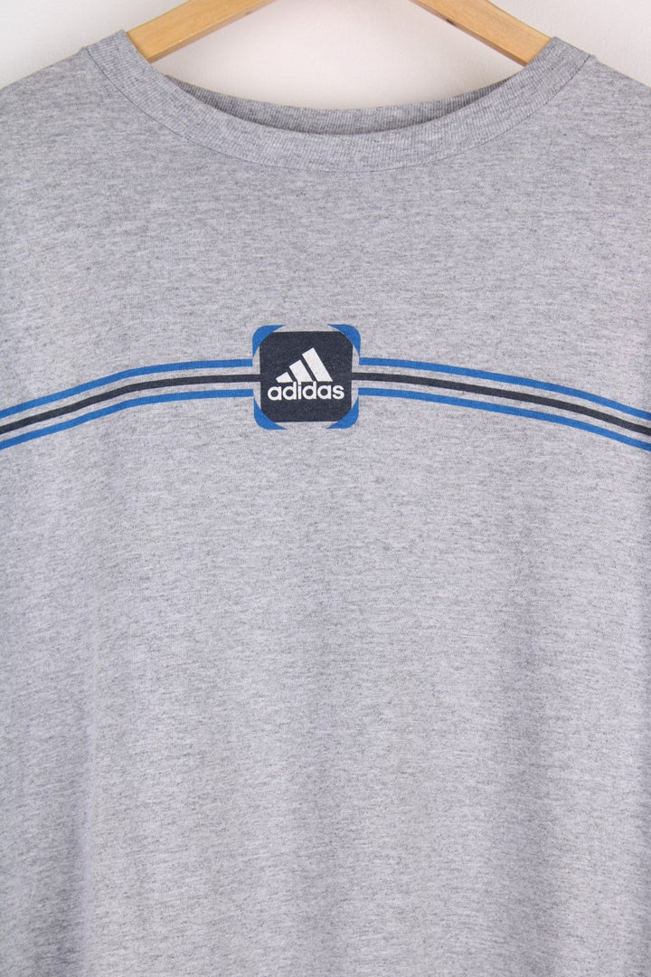 Vintage Early 2000s Adidas T-Shirt in a grey colourway a graphic printed on the front..