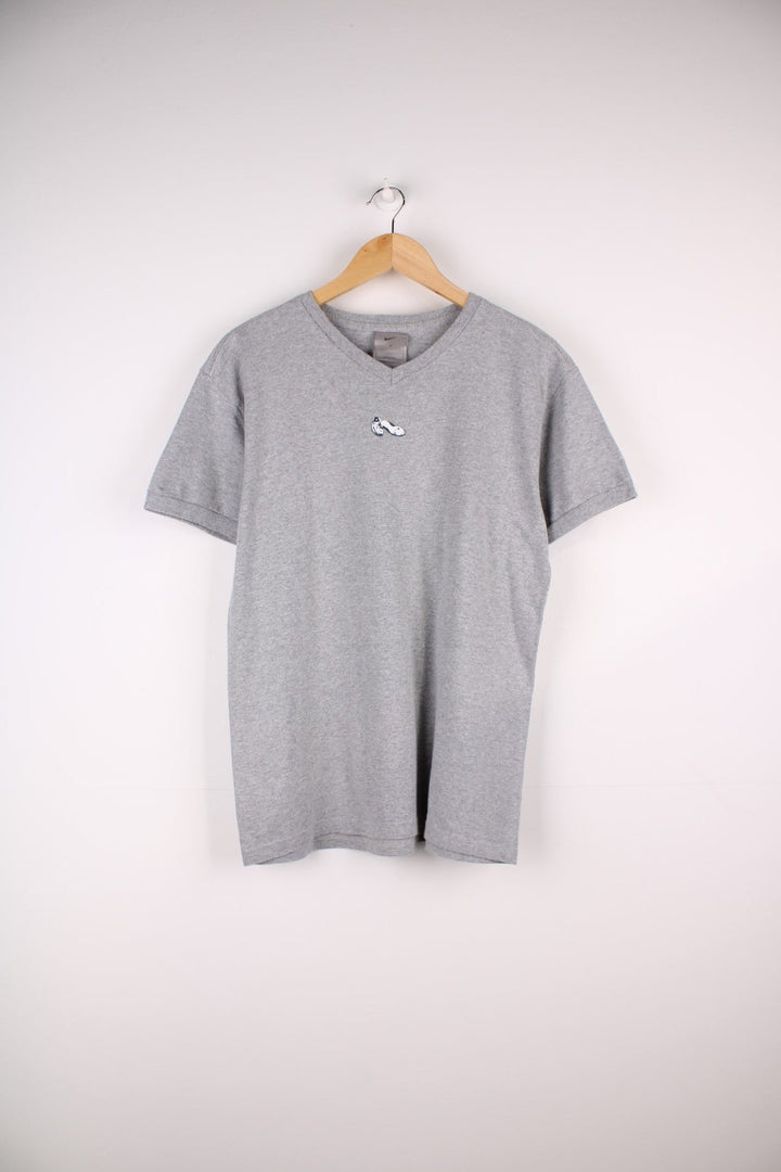 Vintage Nike Run T-Shirt in a grey colourway with a small shoe graphic printed on the front. The shirt has a V neck and capped sleeves. 