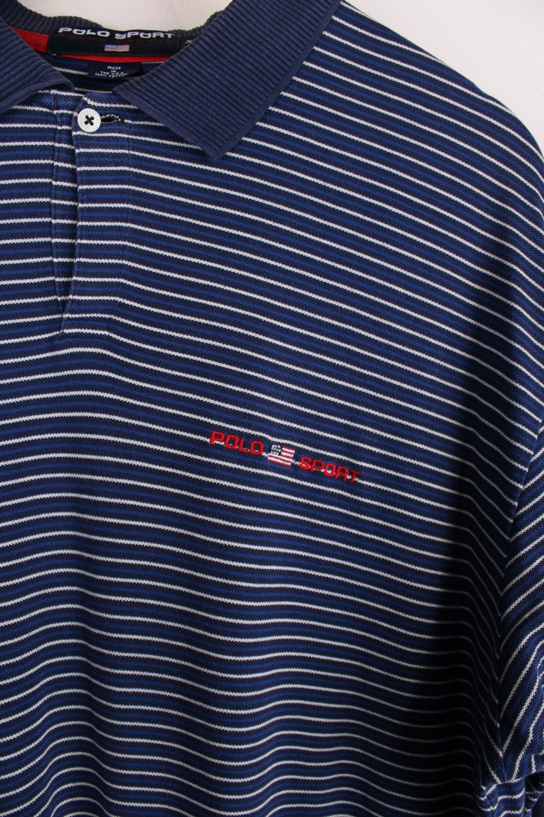 Ralph Lauren Polo Shirt in a navy blue and white stripe. The logo is embroidered on the front. 