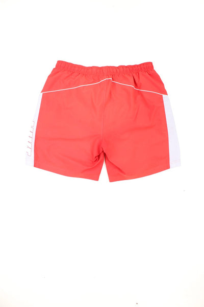 Red Nike drawstring swim shorts with embroidered logo and printed logo down the leg.
