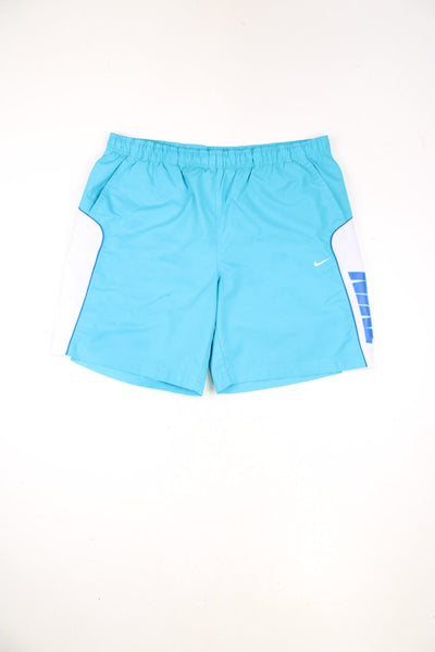 Blue Nike swim shorts with drawstring waist, embroidered logo and printed logo down the leg.