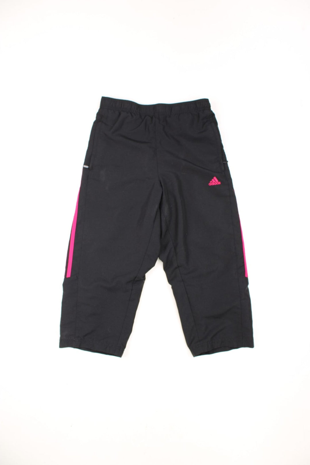 Black and pink Adidas 3/4 length tracksuit bottoms with embroidered logo and signature three stripes down each leg.