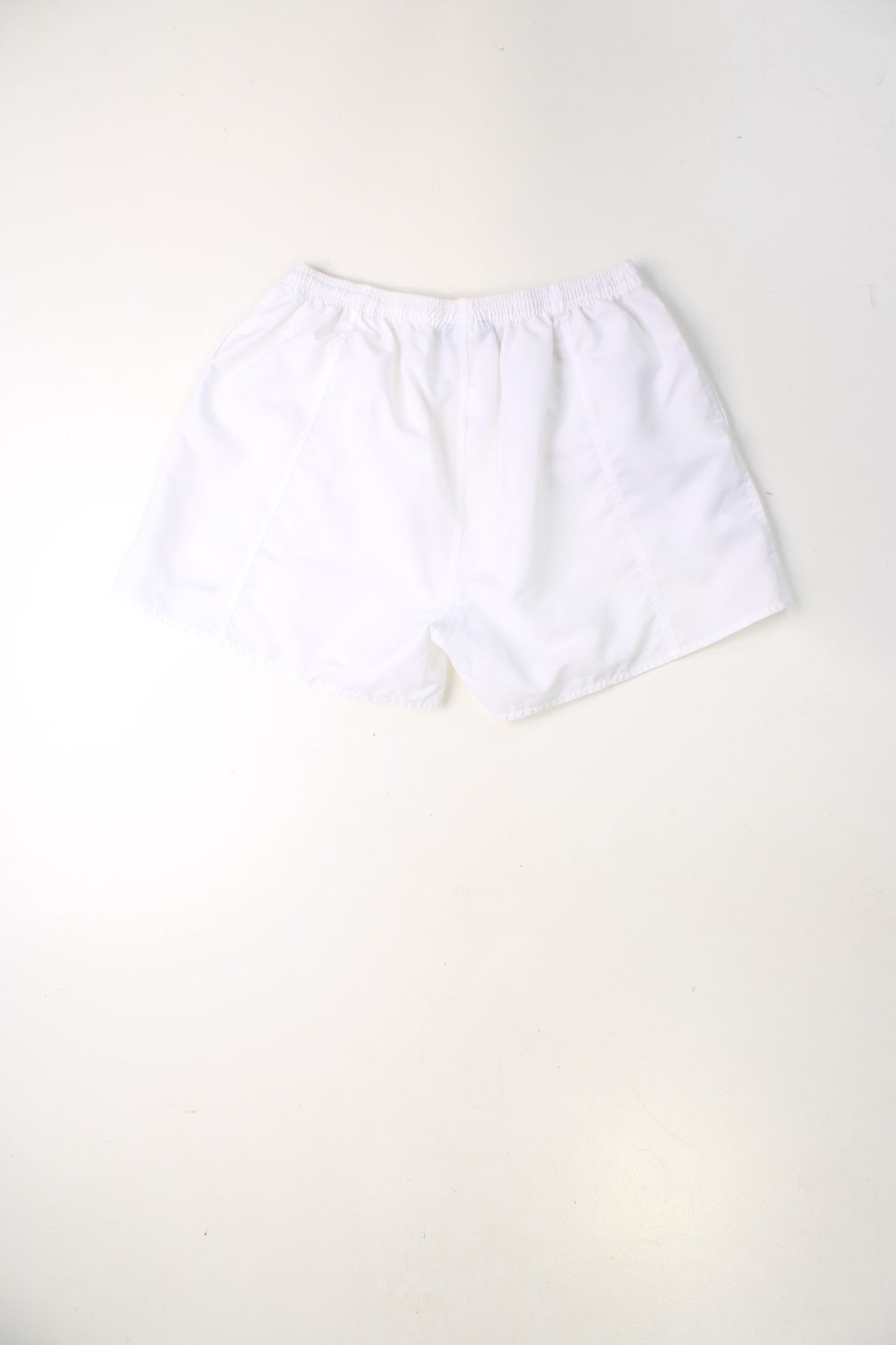 White Reebok shorts with elasticated drawstring waist and embroidered logo.