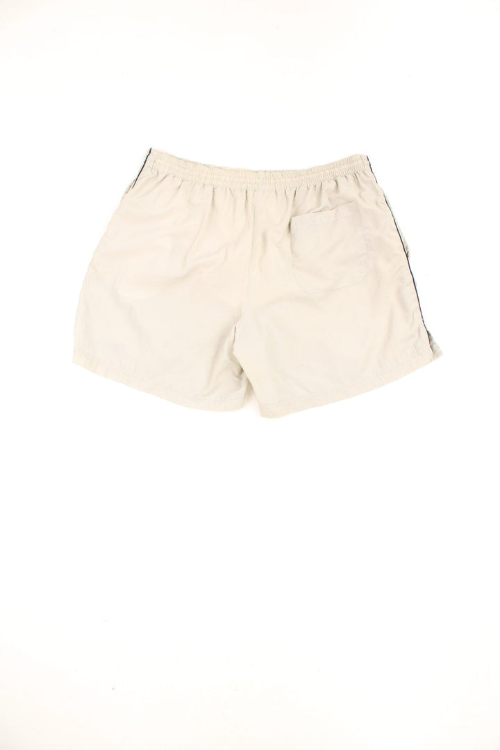 Beige vintage Umbro swim shorts with elasticated drawstring waist and embroidered logo. 