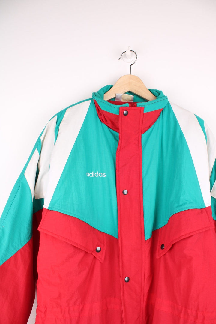 1992/93 Liverpool FC Adidas Bench Coat in a red, green and white colourway, insulated lining, multiple pockets, and has the spell out logo on the front and back. 