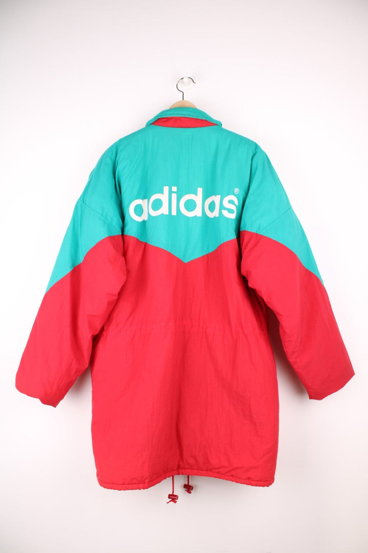 1992/93 Liverpool FC Adidas Bench Coat in a red, green and white colourway, insulated lining, multiple pockets, and has the spell out logo on the front and back. 