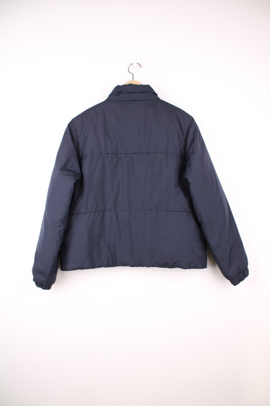 Reebok Puffer Coat in a navy blue colourway, zip up with side pockets, insulated lining, and has the logo embroidered on the front. 