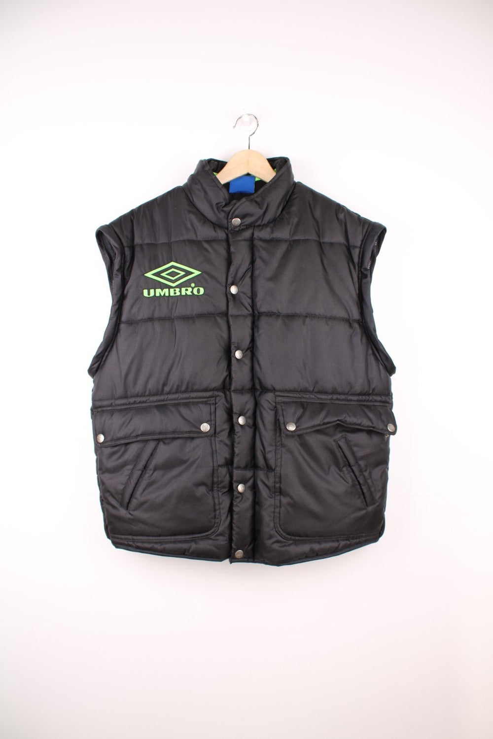 Umbro Pro Training Puffer Coat with detachable sleeves to turn into a gilet, black colourway with neon green logos embroidered on the front, back and sleeve.