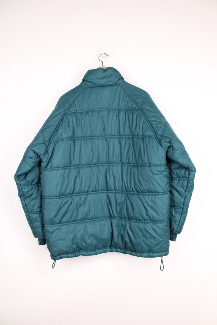 Umbro Puffer Coat in a blue colourway, zip up with side pockets, insulated, and has the logo embroidered on the front. 