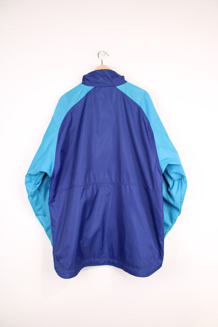 Adidas Training Jacket in a blue colourway with the iconic three stripes going down the sleeves, zip up with side pockets, and has the logo embroidered on the front. 