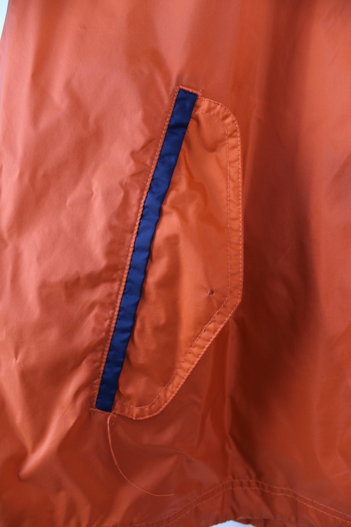 Vintage Nike lightweight windbreaker jacket in orange, blue and white. Features embroidered logo on the chest, printed logo on the back and a pack away hood.