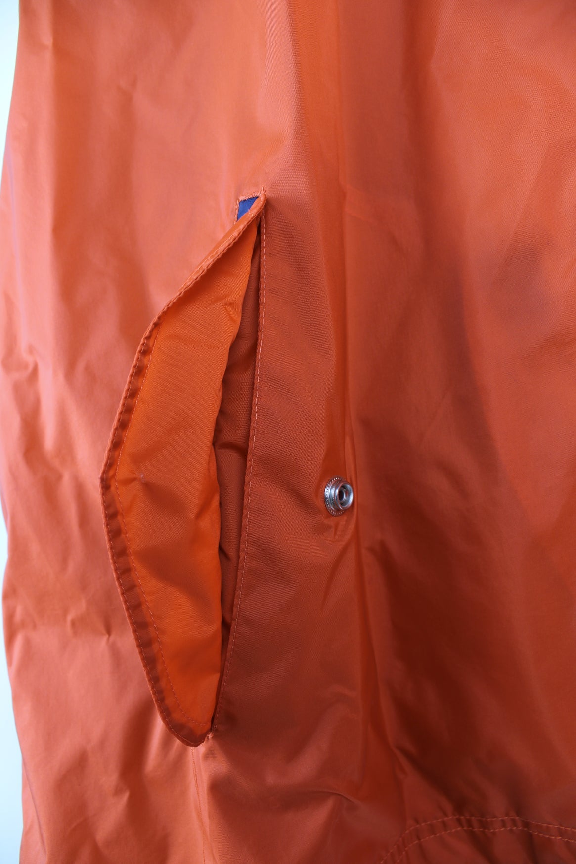 Vintage Nike lightweight windbreaker jacket in orange, blue and white. Features embroidered logo on the chest, printed logo on the back and a pack away hood.