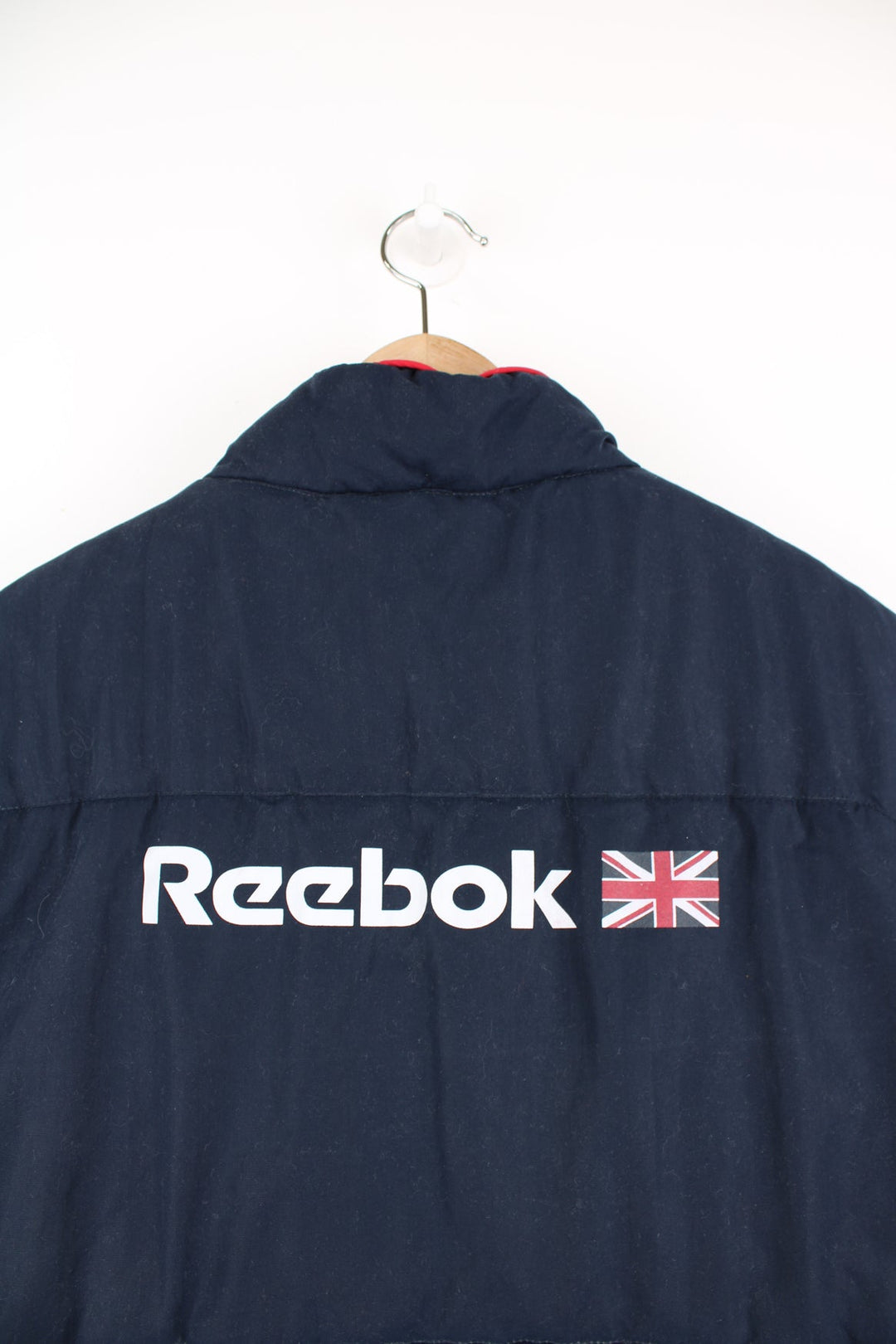 Reebok Classic blue and red gilet featuring embroidered logo on the chest and printed logo across the back.