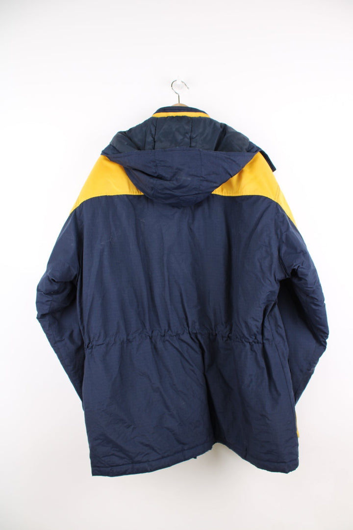 Vintage Reebok Athletic Dept blue and yellow coat. Features removable hood and embroidered logo.