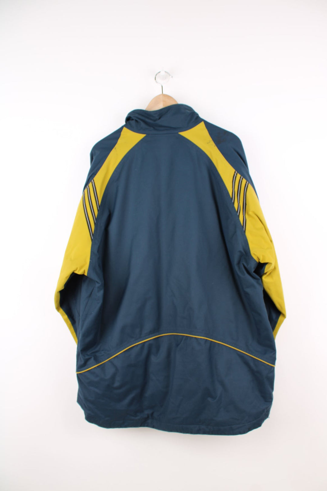 Vintage Adidas coat in blue and yellow. Features embroidered logo.