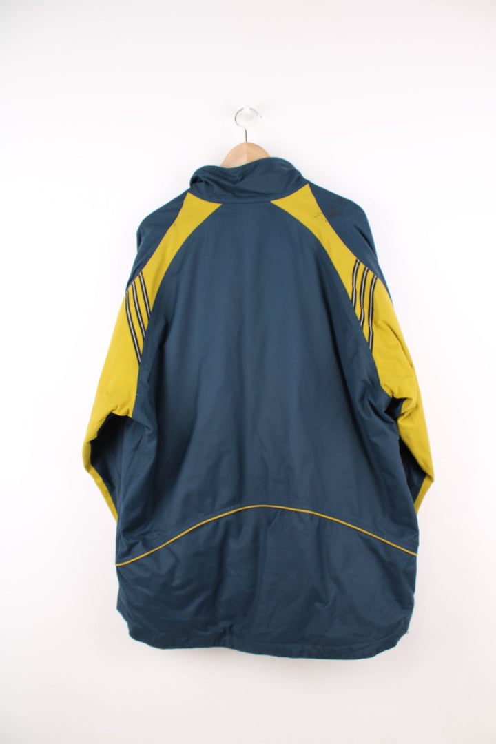 Vintage Adidas coat in blue and yellow. Features embroidered logo.